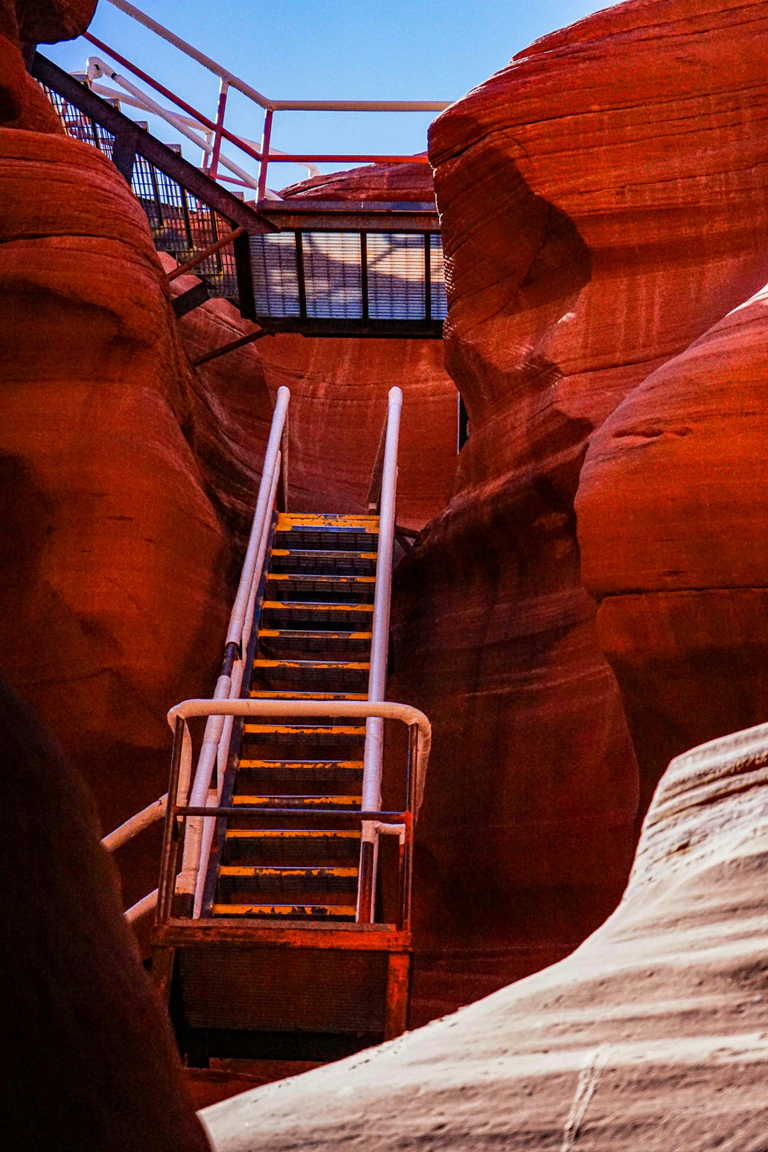 Metal stairs between sandstone walls on the Lower Antelope Canyon route