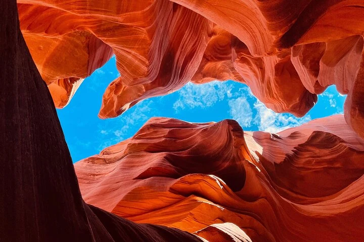 Bright blue sky framed by sculpted canyon walls