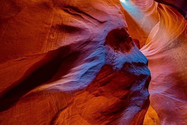 Red and blue light across sculpted Antelope Canyon walls
