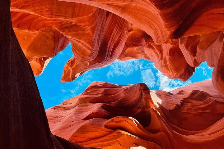 Blue sky framed by red sandstone inside Lower Antelope Canyon