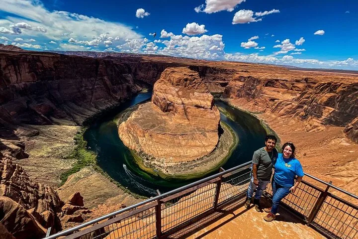 Travelers at the Horseshoe Bend overlook above the Colorado River